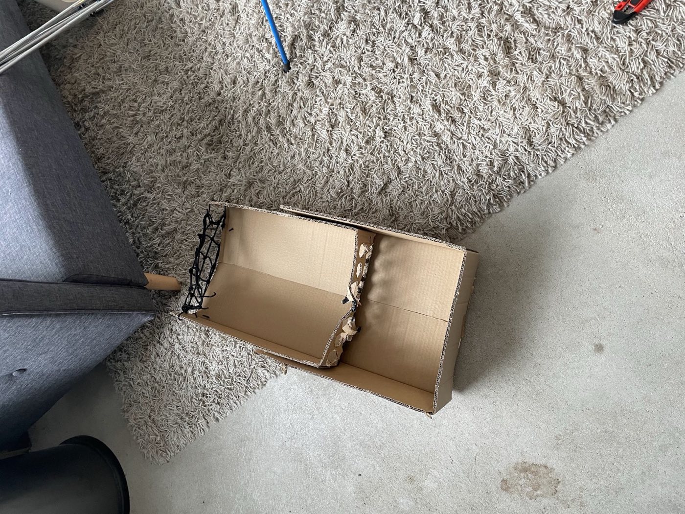The first VeloCaddie mock-up: a cardboard box with a black bungee net across the top.